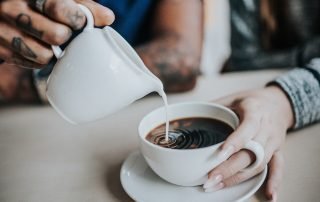 collagen creamer being poured into a collagen coffee