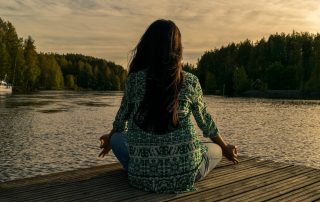 Woman ensuring mental wellness by meditating